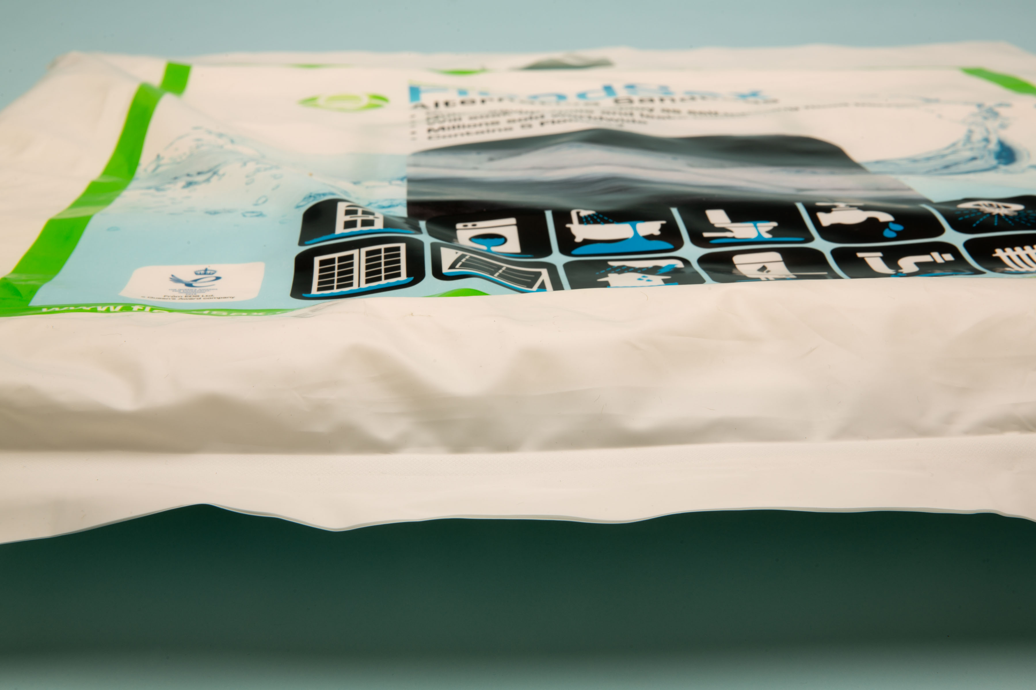 Close-up high-resolution image of a single FloodSax packaging, featuring clear branding and illustrative images demonstrating its flood defense applications.