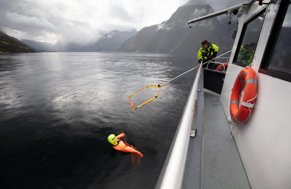 A Man securing man overboard training dummy in vertical rescue position using SB Rescue Sling